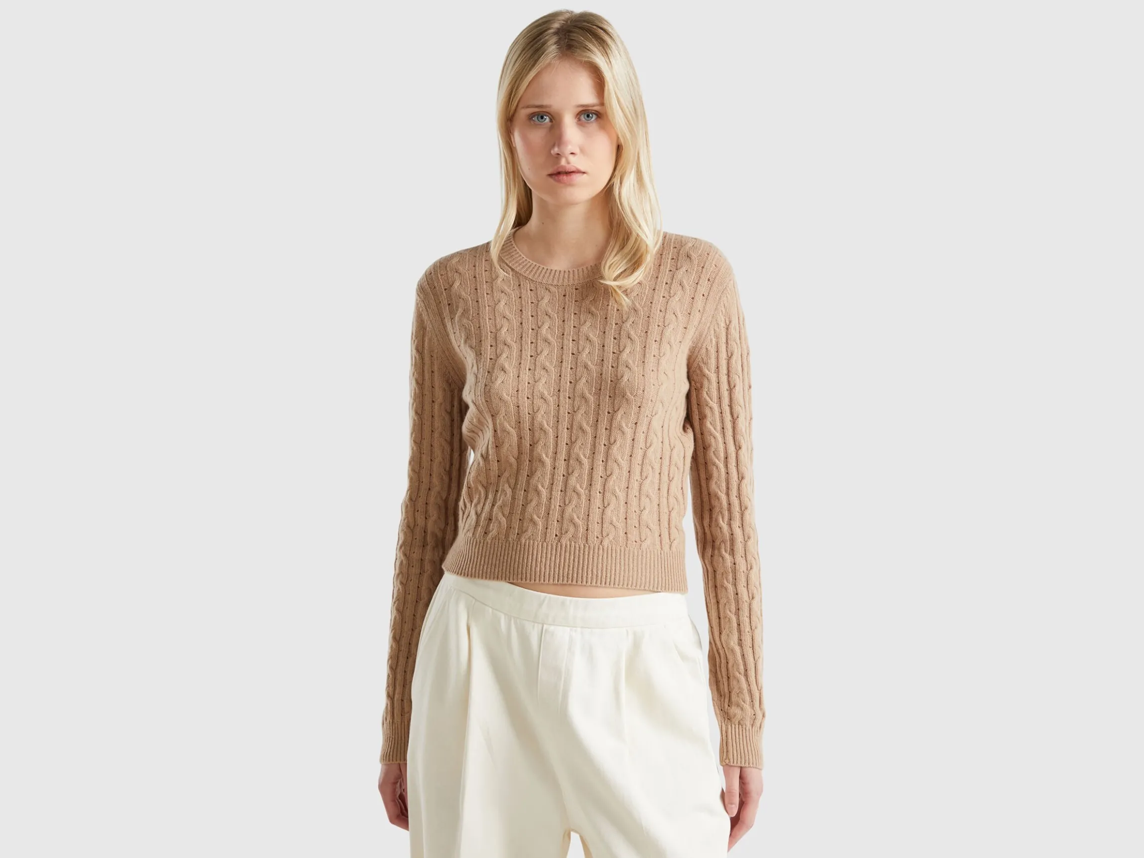 Cropped sweater with cable knit and perforations