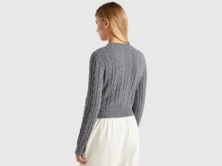 Cropped sweater with cable knit and perforations
