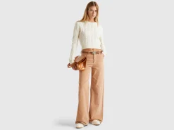 Cropped sweater with cable knit and perforations