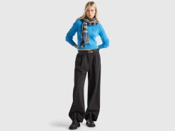 Cropped sweater with cable knit and perforations