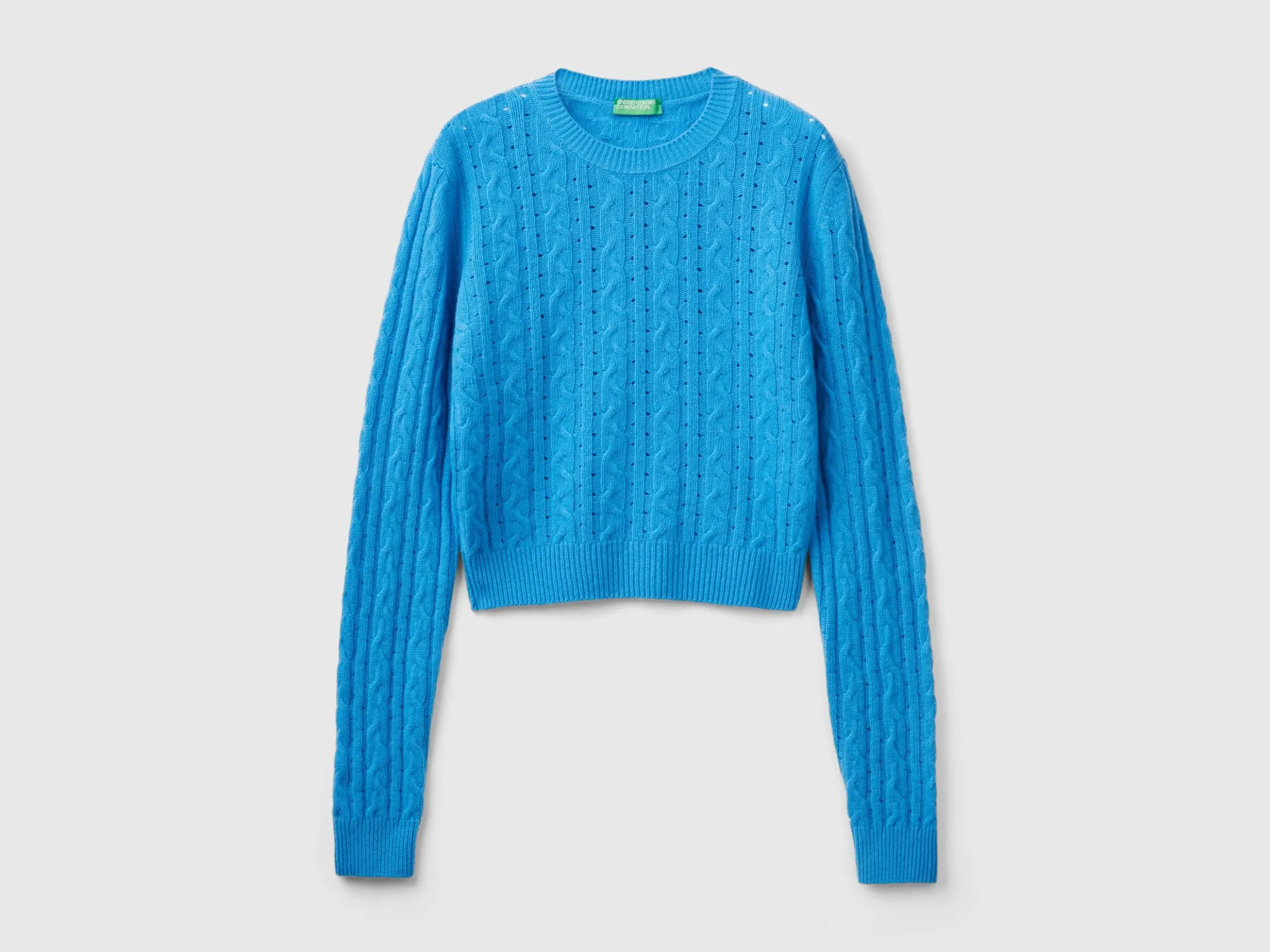 Cropped sweater with cable knit and perforations