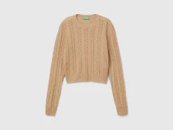 Cropped sweater with cable knit and perforations