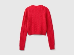 Cropped sweater with cable knit and perforations