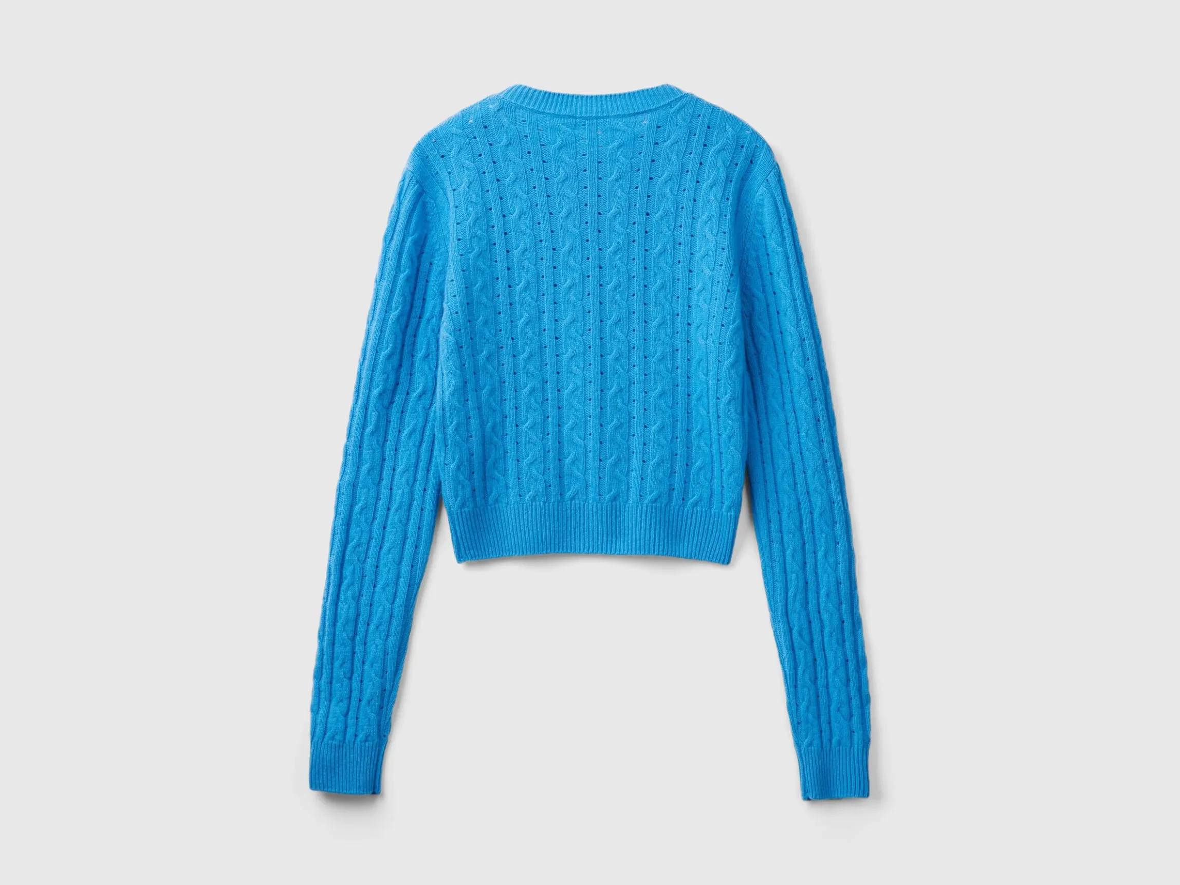Cropped sweater with cable knit and perforations