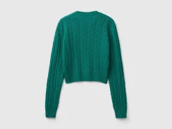 Cropped sweater with cable knit and perforations