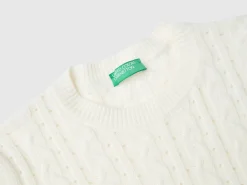 Cropped sweater with cable knit and perforations