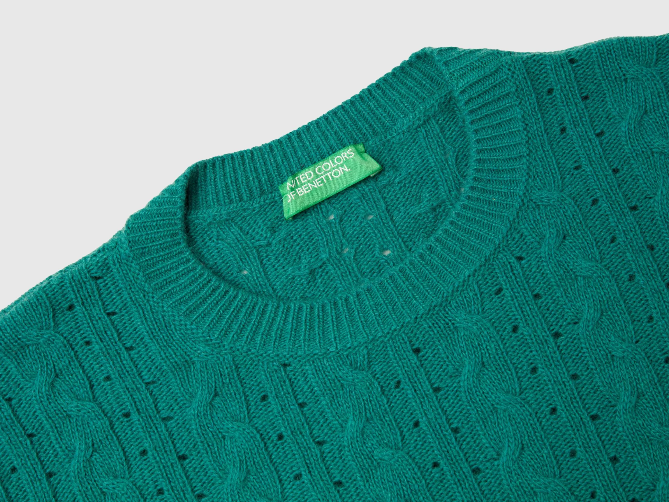 Cropped sweater with cable knit and perforations