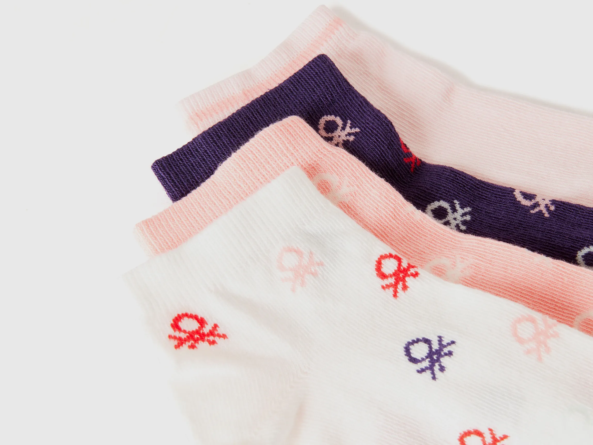 Four pairs of short socks with logos