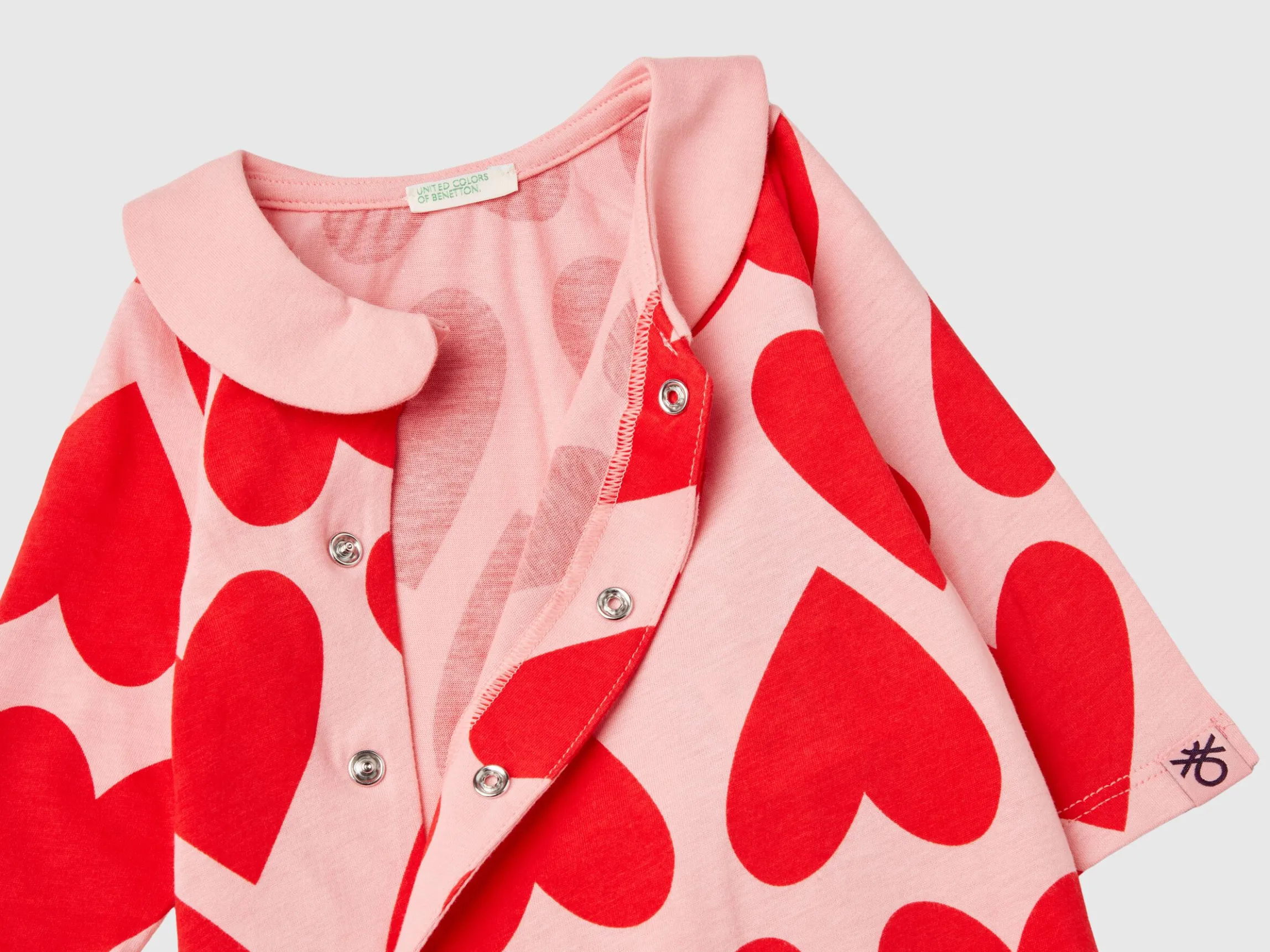 Long pink onesie with heart print