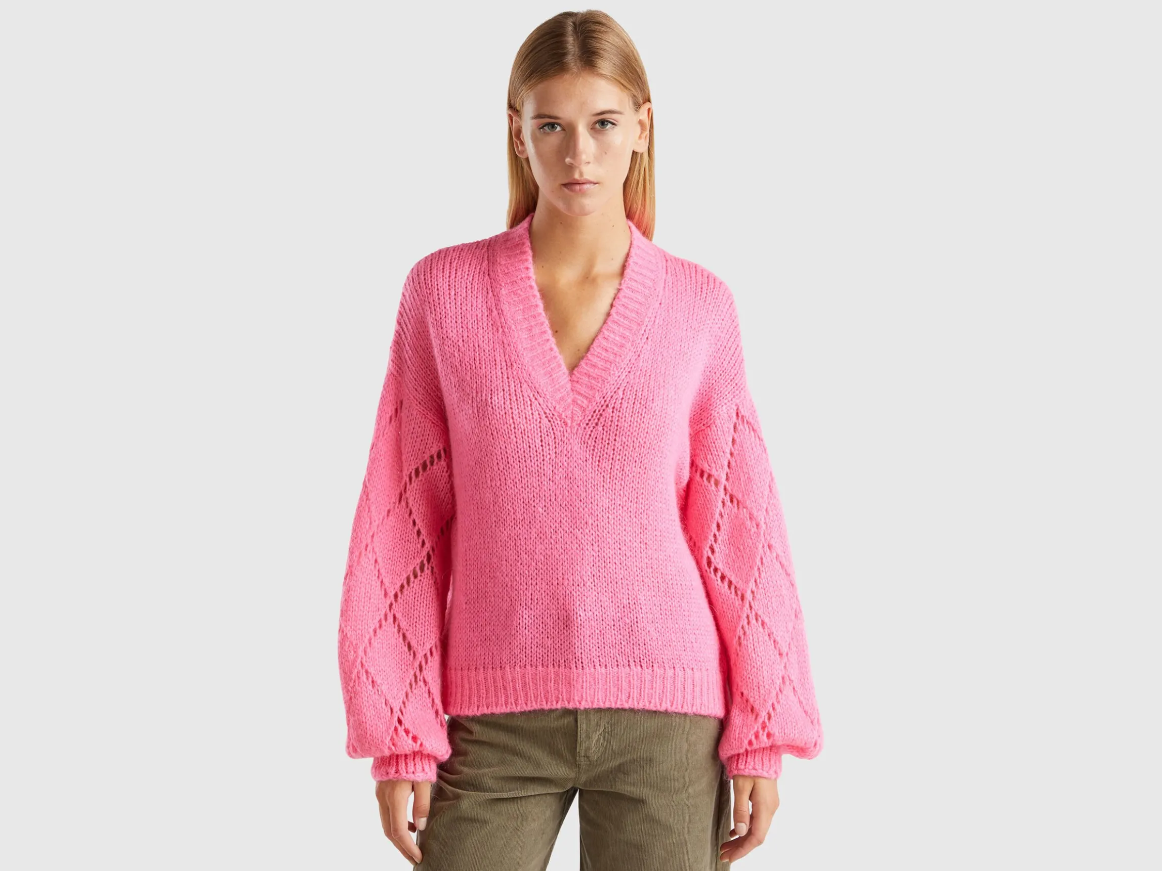 Sweater with perforated sleeve