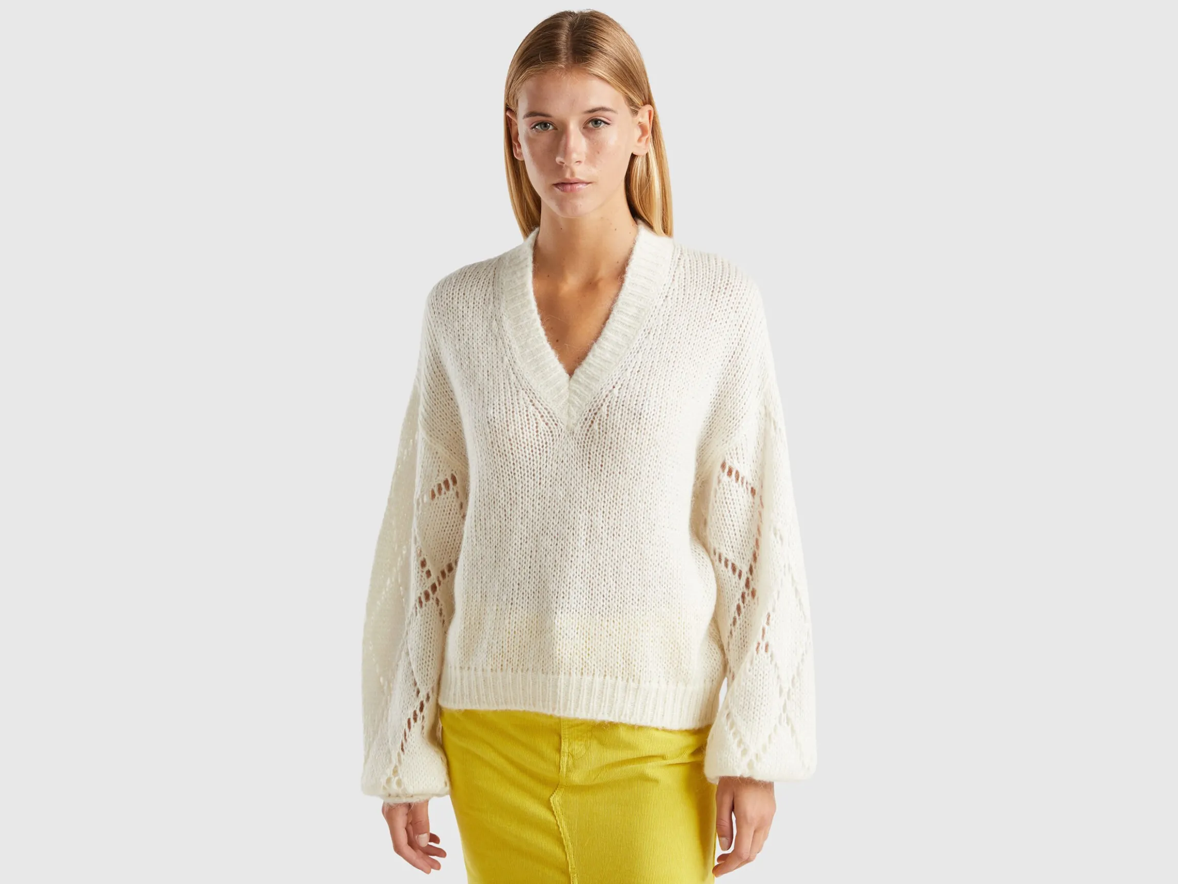 Sweater with perforated sleeve