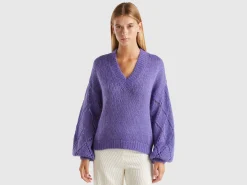 Sweater with perforated sleeve