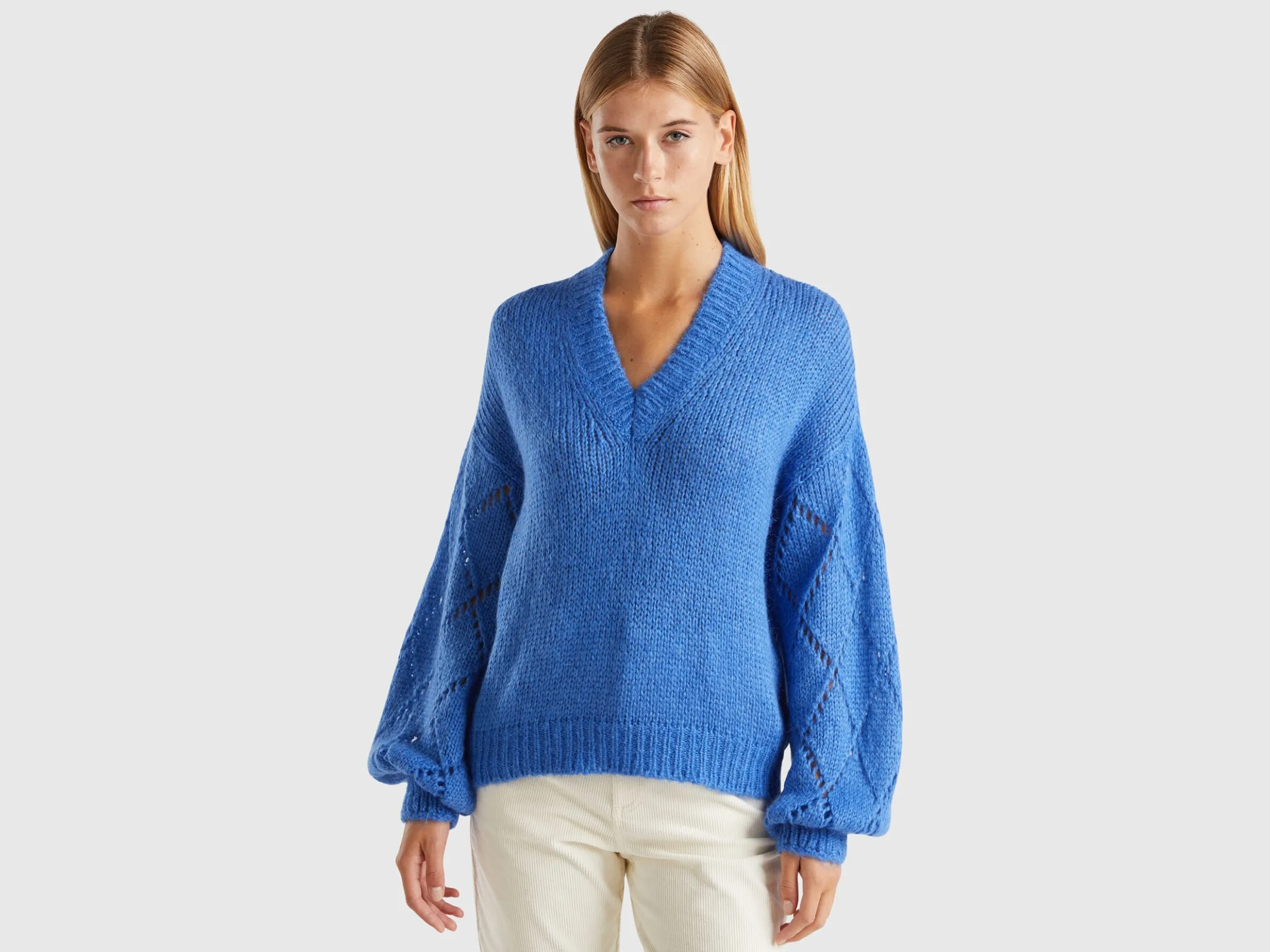 Sweater with perforated sleeve