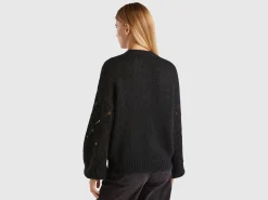 Sweater with perforated sleeve