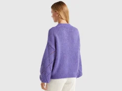 Sweater with perforated sleeve