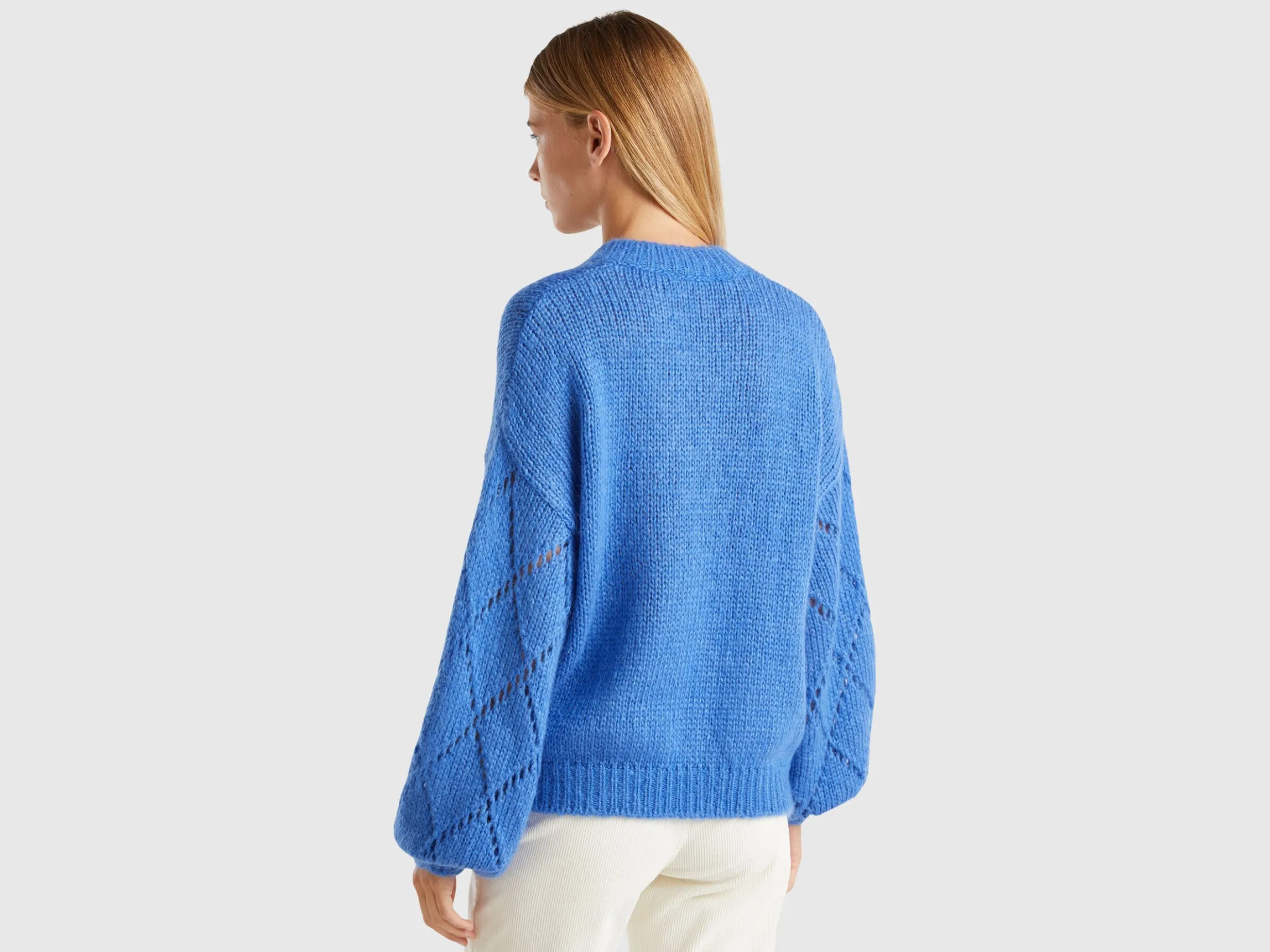 Sweater with perforated sleeve