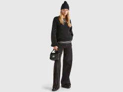 Sweater with perforated sleeve