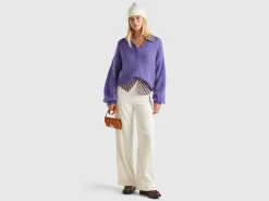 Sweater with perforated sleeve