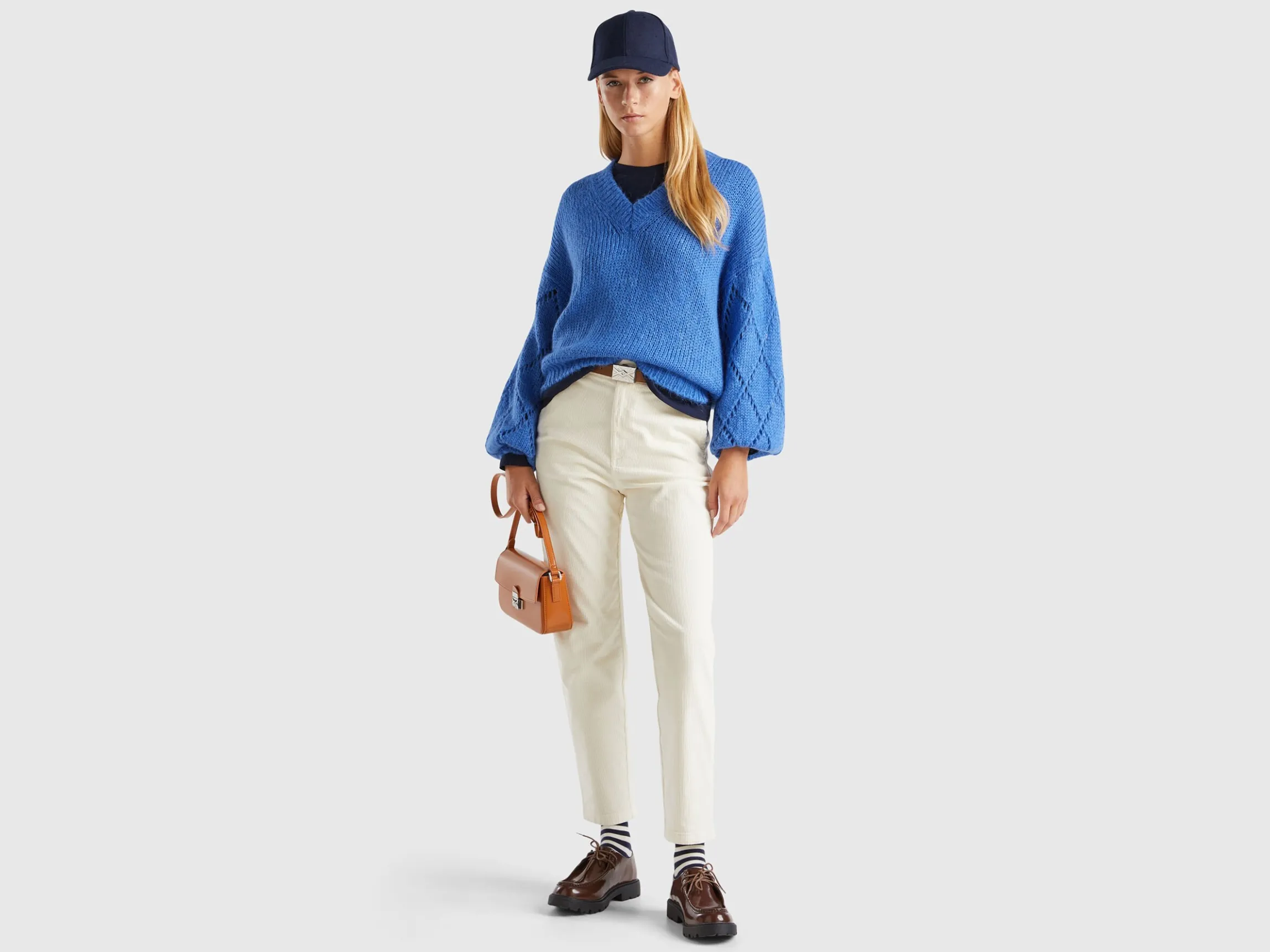 Sweater with perforated sleeve