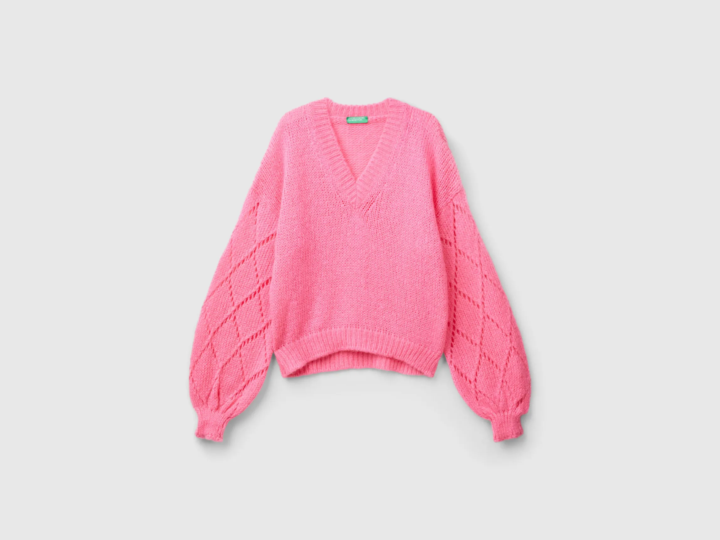 Sweater with perforated sleeve