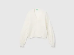 Sweater with perforated sleeve