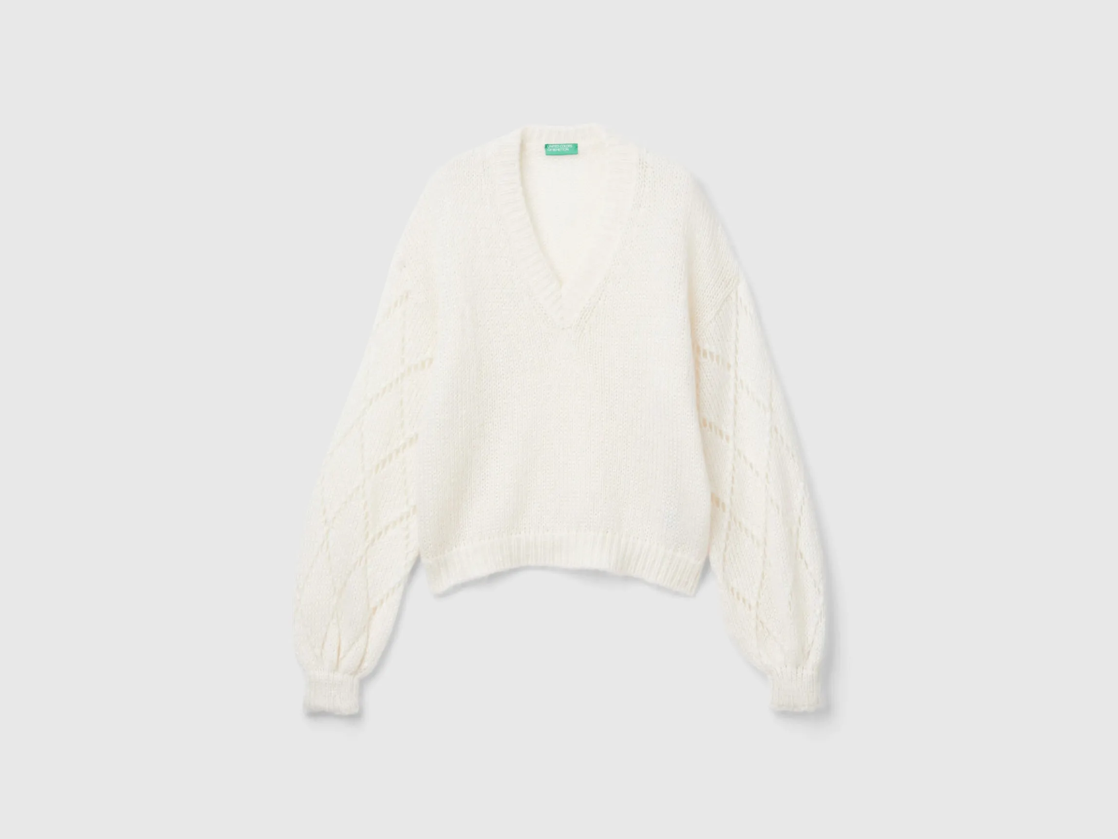Sweater with perforated sleeve