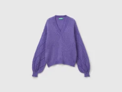 Sweater with perforated sleeve