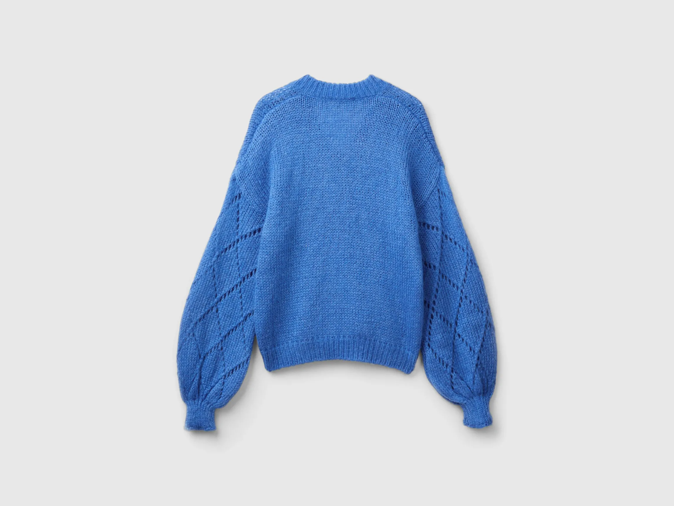 Sweater with perforated sleeve