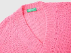 Sweater with perforated sleeve