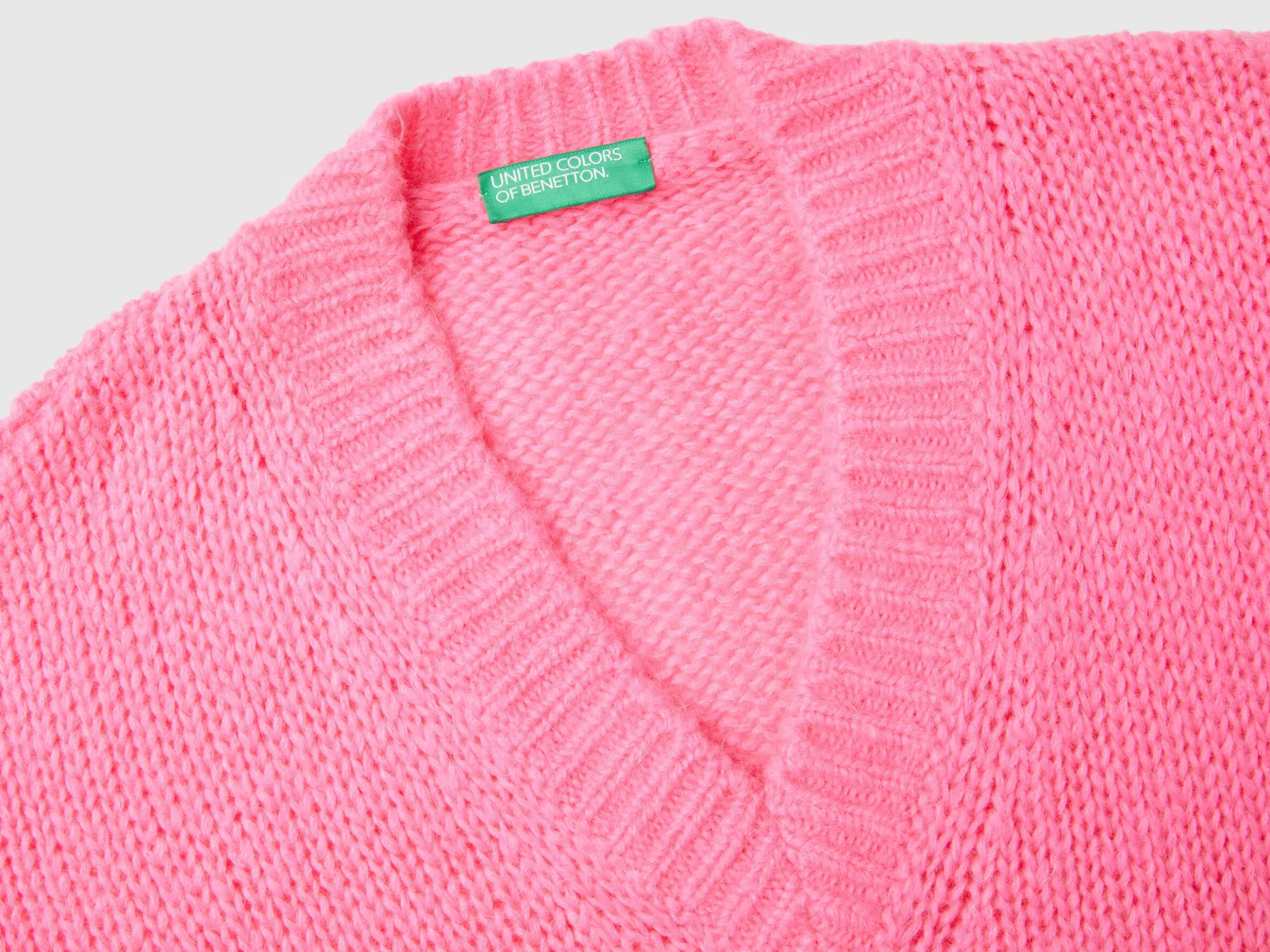Sweater with perforated sleeve