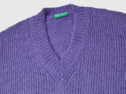 Sweater with perforated sleeve
