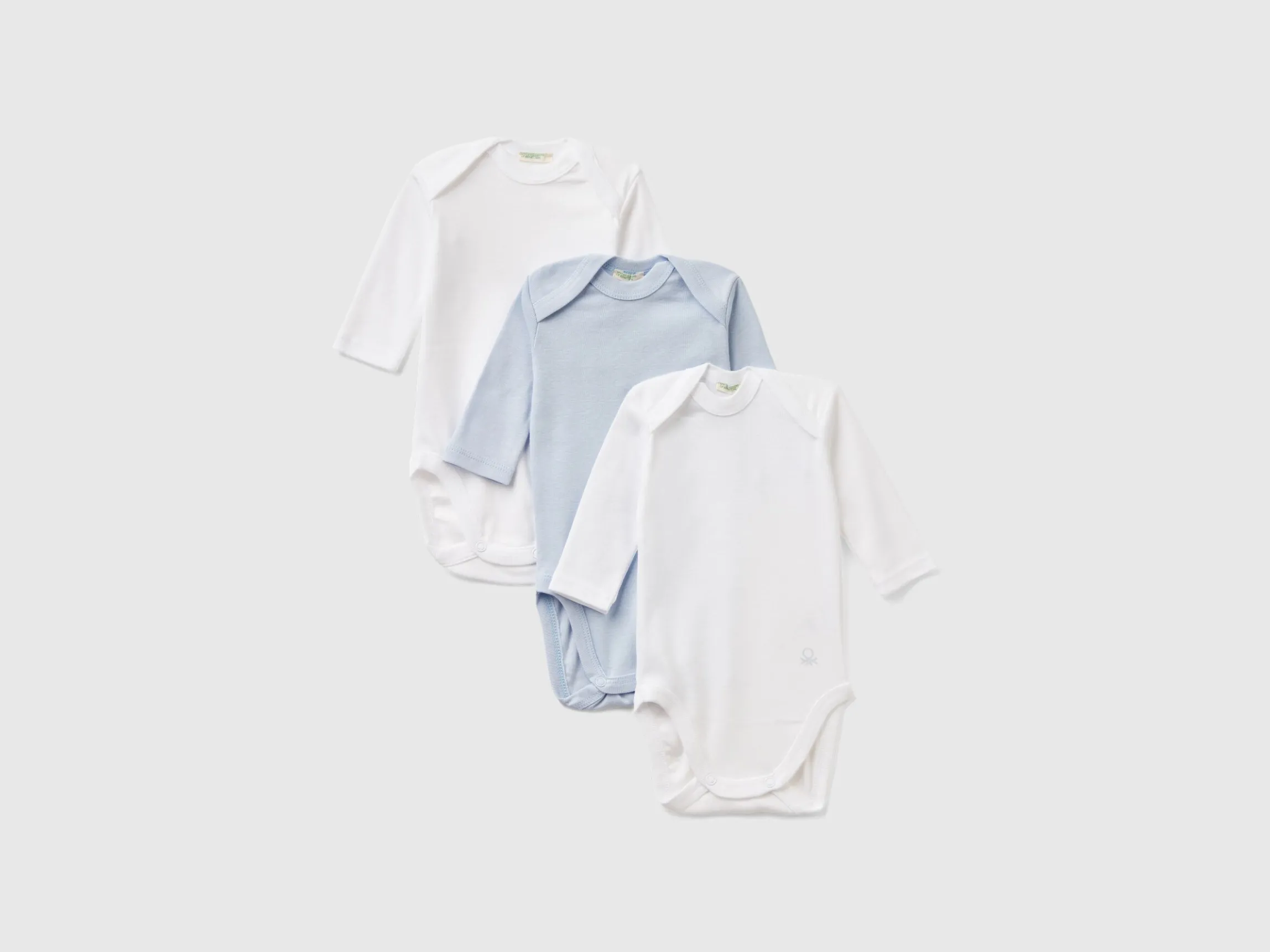 Three solid color bodysuits in organic cotton