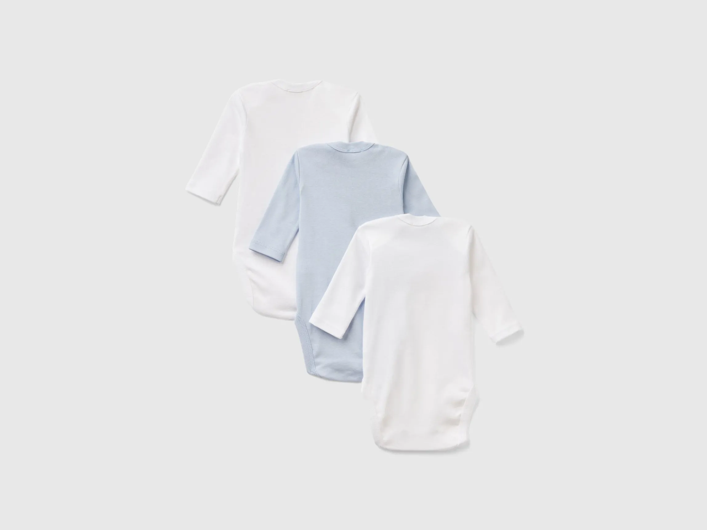 Three solid color bodysuits in organic cotton