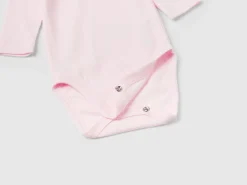 Three solid color bodysuits in organic cotton