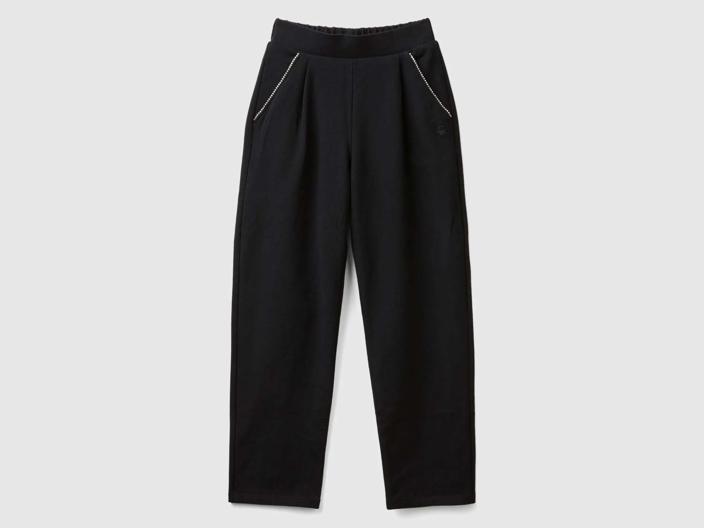 Trousers with jewel-like applique