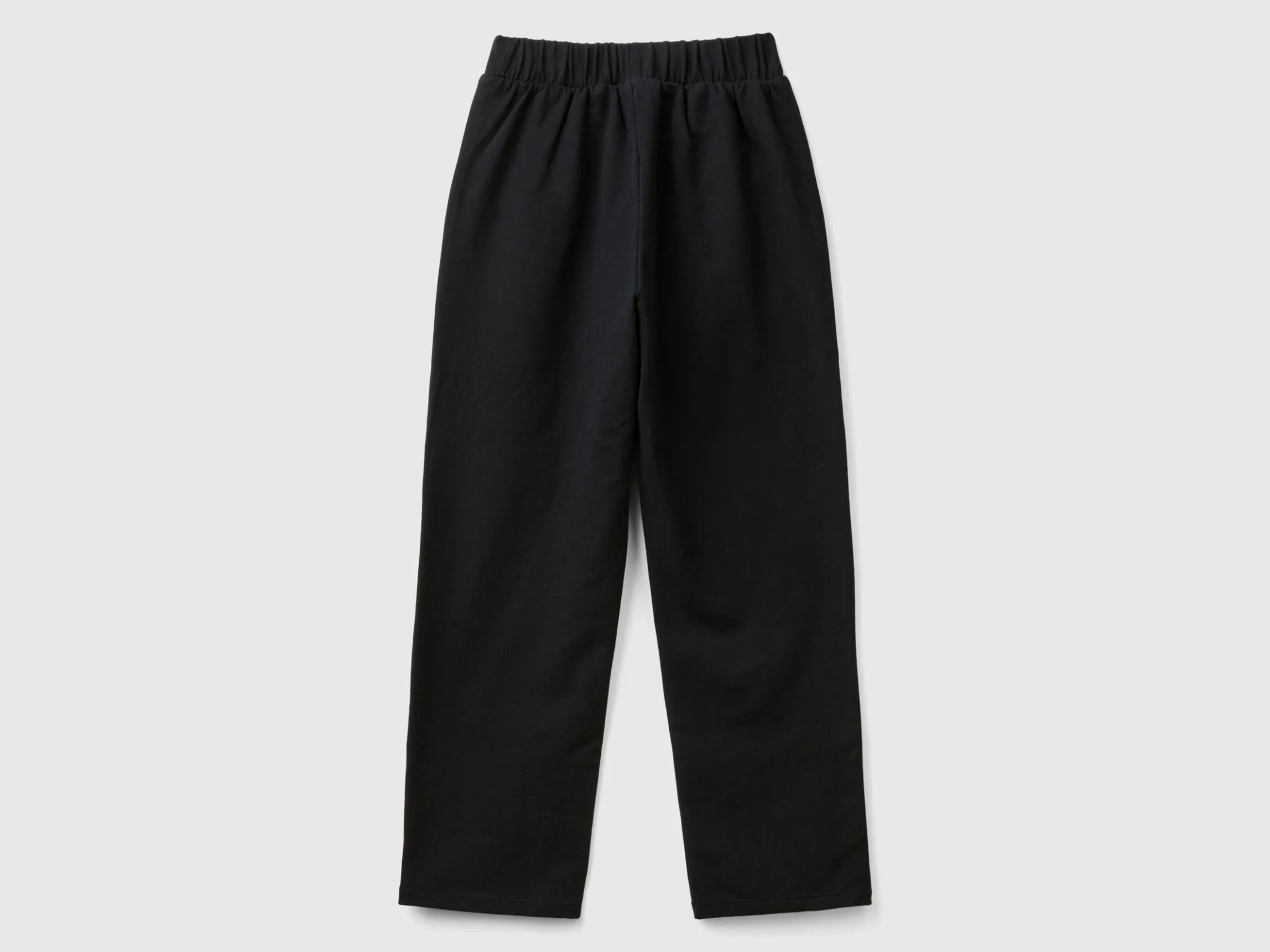 Trousers with jewel-like applique