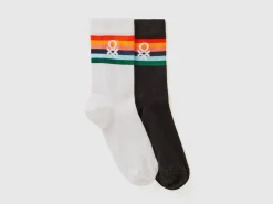 Two pairs of long socks with logos